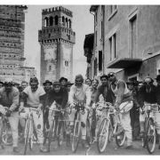"239 - Gruppo ciclistico in posa Sullo sfondo una torre a merli in città non definita